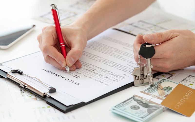 signing the agreement with keys in the hand